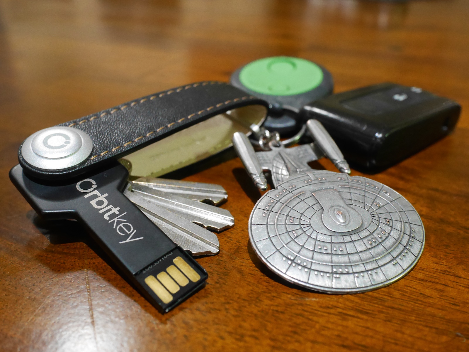 photo of an Orbitkey on a wooden surface with keys and other accessories attached